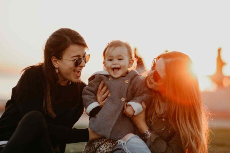 two moms and daughter happy